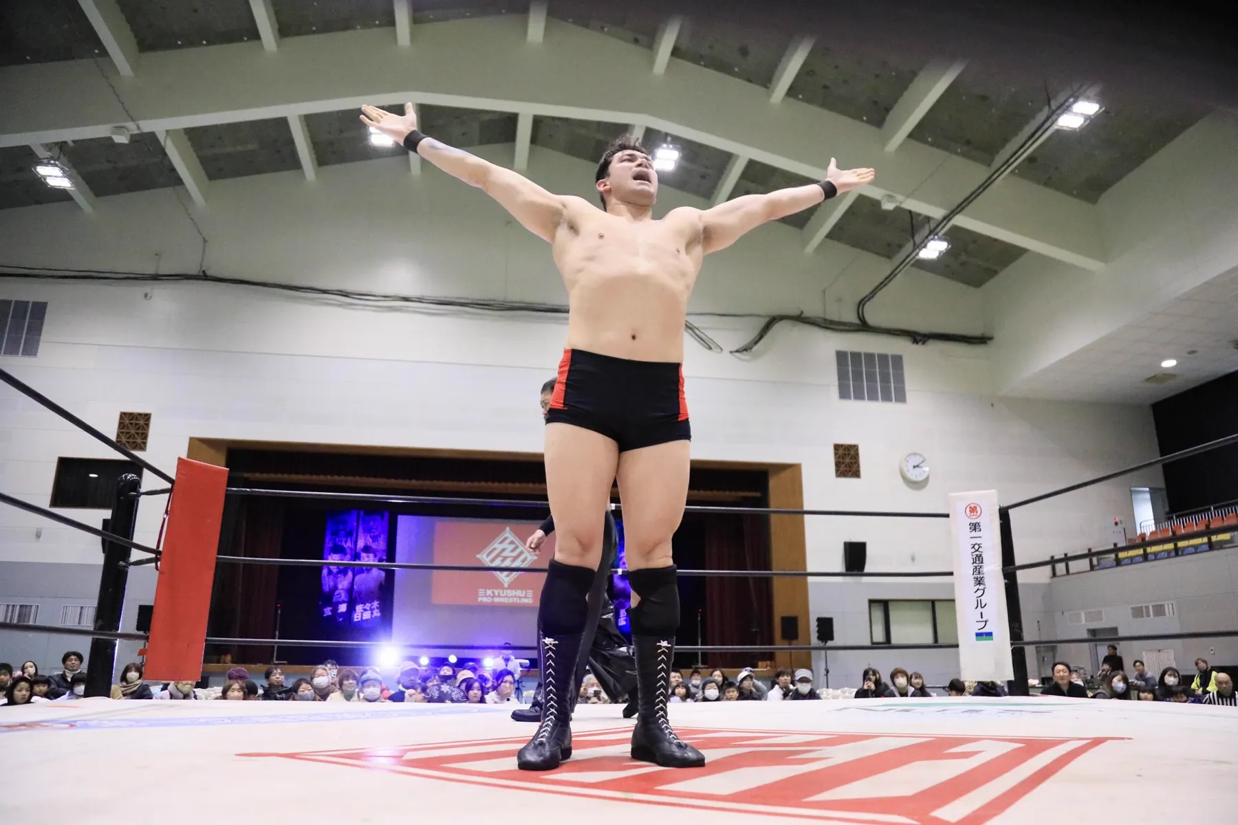 Handsome Jay with arms spread wide in the ring